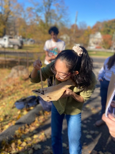 Student partakes in bone burning